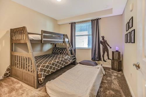 a bedroom with two bunk beds and a window at H - New 2 Bedroom Condo - 5 Miles to Disney - Free Water Park in Kissimmee