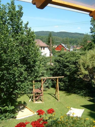 a playground in a yard with a wooden swing at Chalupa Horní Lánov in Dolni Dvur