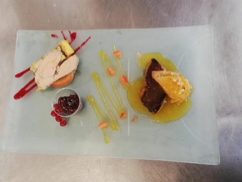 a white plate with some food on a table at le relais des forêts in Blessac