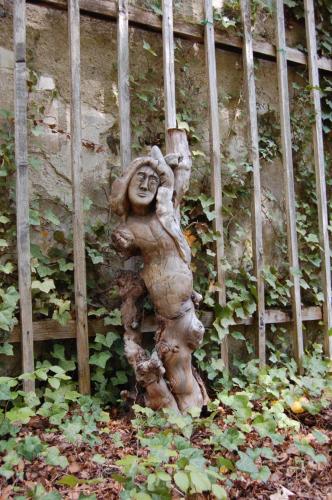 a statue of a woman standing next to a wall at Glögglhof in Trofaiach