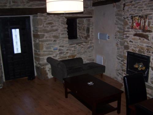 a living room with a couch and a fireplace at Alojamiento Luz de Hadas in Sampil