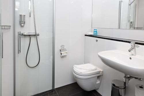 a bathroom with a shower and a toilet and a sink at Best Western Hotel Arena in Gothenburg