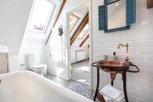 a bathroom with a tub and a sink and a toilet at Casa Carolina Brasov in Braşov
