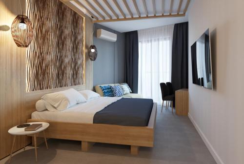 a bedroom with a bed and a table and a tv at Mykonos Hotel Apart - Maestro in Odesa
