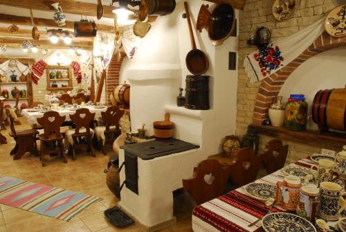 a restaurant with a stove in the middle of a room at Crama Haiducilor in Cluj-Napoca