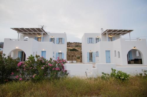 a row of white houses with flowers in the foreground at Magganari Moments 3 in Manganari