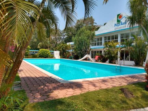 a swimming pool in front of a building at Hotel Playa Azul in Catemaco