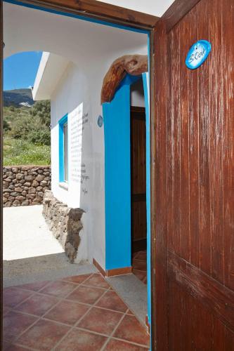 an entrance to a building with a blue door at Agriturismo Codula Fuili in Cala Gonone