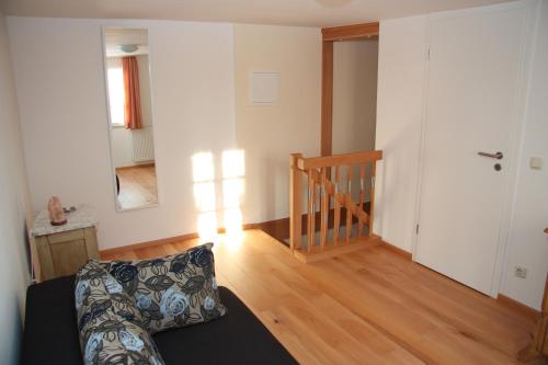 a living room with a couch and a wooden floor at Ferienwohnung Dürbaum in Schleiden