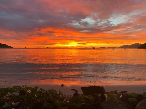 a sunset on the beach with the ocean at 88 Days Self Catering Holidays & Accomodation in Baie Lazare Mahé