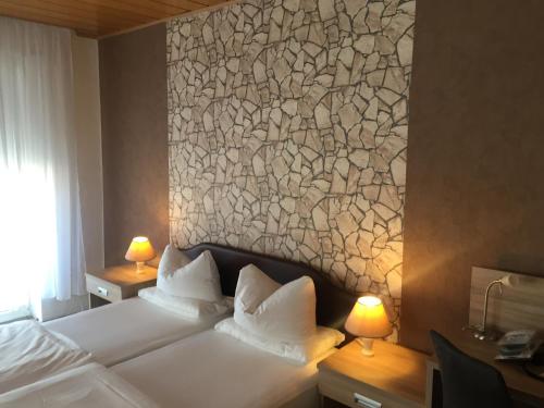 a bedroom with a white bed with a wall mural at Hotel Restaurant Alexandros in Mannheim
