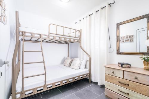 a bedroom with a bunk bed with a mirror and a dresser at Villa Iceberg Mini in Kalamaki Heraklion