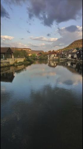 a large body of water with houses and buildings at LA 3Eme RIVES A ORNANS in Ornans
