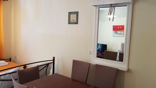 a dining room with a table and a mirror at Nefeli Wind Club in Vasiliki