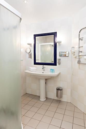 a bathroom with a sink and a mirror at Center Hotel - Sure Hotel by Best Western in Gothenburg