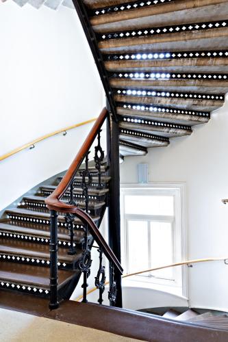 a spiral staircase with a wooden rail and a window at Center Hotel - Sure Hotel by Best Western in Gothenburg