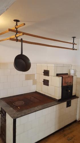 a kitchen with a utensil hanging from a ceiling at Kloiberhof in Öblarn