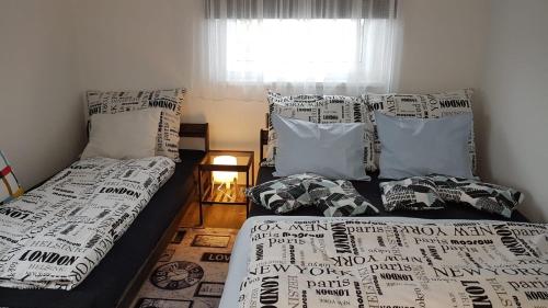 a bedroom with two beds covered in newspaper at Apartmány Tylovice in Rožnov pod Radhoštěm