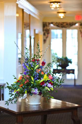 a vase filled with flowers sitting on a table at Avon Old Farms Hotel in Avon