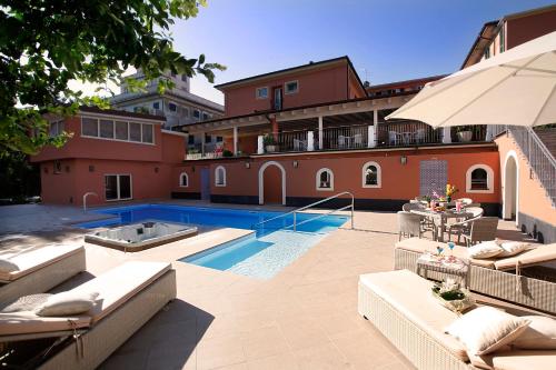 a swimming pool in front of a building at Hotel Monte Rosa in Chiavari