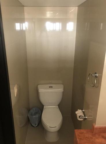 a bathroom with a white toilet in a stall at Hotel Maria del Rocio in Veracruz