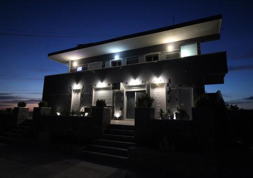 a night view of a house with lights on it at Le Gjero luxury villa in Ksamil