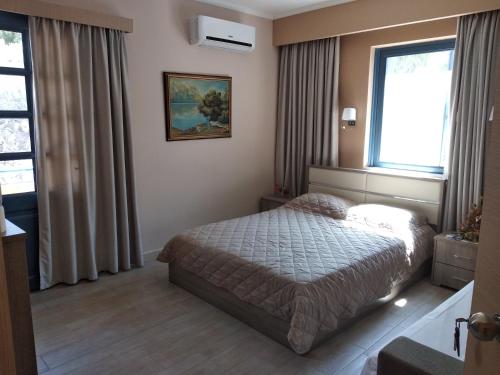 a hotel room with a bed and a window at Vista Del Mare Rooms in Nafplio