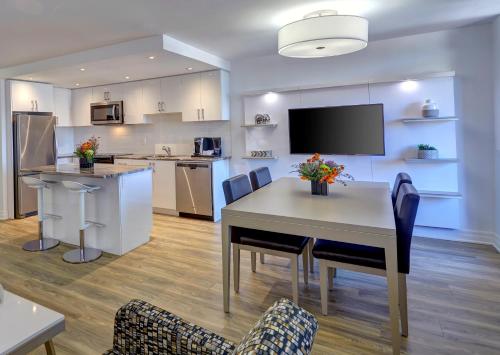 a kitchen and dining room with a table and chairs at Town Inn Suites Hotel in Toronto