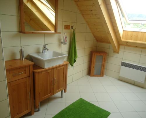 a bathroom with a sink and a window at Srub Losiny in Velké Losiny