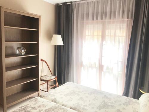 a bedroom with a bed and a window at Pisos Centro Ribadesella in Ribadesella