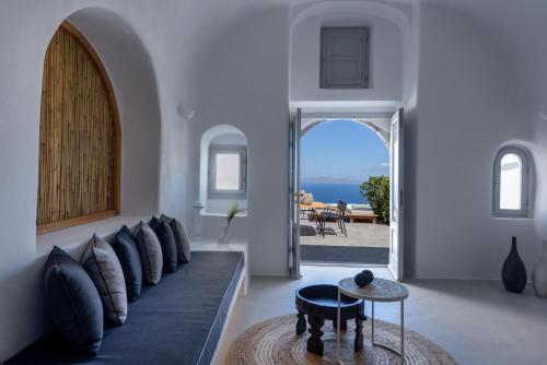 a living room with a couch and a table at Adele Villa by Senses Collection in Pirgos