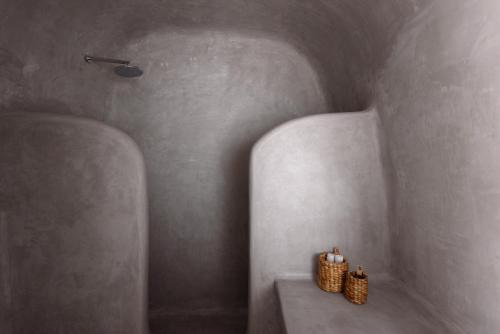 a bathroom with two candles sitting on a table at Adele Villa by Senses Collection in Pirgos