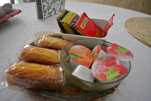 a plate of pastries and a bowl of fruit on a table at La Scala Rho B&B in Rho