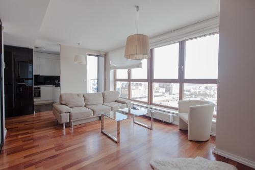 a living room with a couch and a table at Sea Towers Gdynia in Gdynia