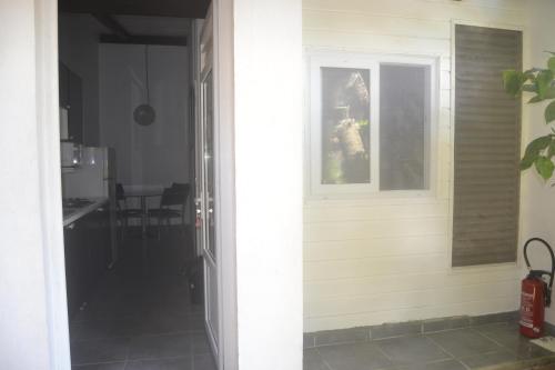 a door leading into a kitchen with a table at an eol caraibes in Trois-Rivières