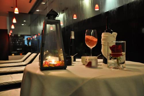 a table with a bottle of wine and a glass at Sol Victoria Hotel SPA & Casino in Victoria