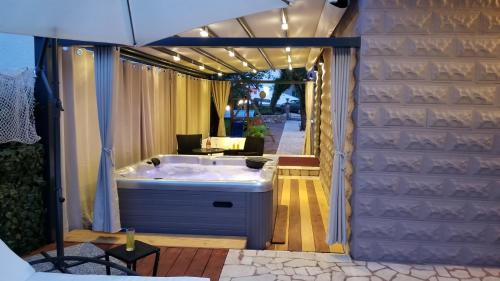 a bath tub in the middle of a room at Villa Summer dream with heated pool, sauna and jacuzzi in Malinska