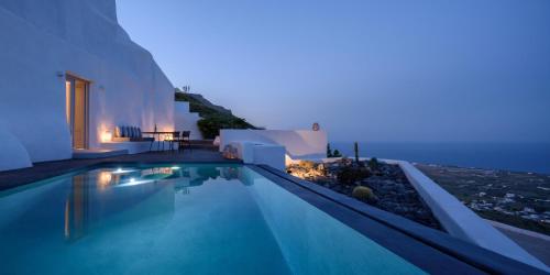 a villa with a swimming pool at night at Delilah Villa by Senses Collection in Pirgos