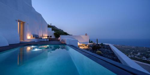 a villa with a swimming pool at night at Delilah Villa by Senses Collection in Pyrgos