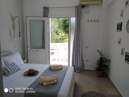 a bedroom with a bed with two towels on it at Paleokastritsa Studios - Sun's Gift Spiros in Paleokastritsa