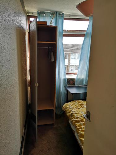 a small bedroom with a bed and a closet at Quiet room in Eltham in London