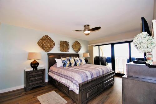 a bedroom with a bed and a ceiling fan at Ocean Vista Condo Unit #1201 in South Padre Island
