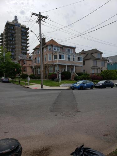 a street with houses and cars parked on the street at Harbor House Bed and Breakfast in Staten Island