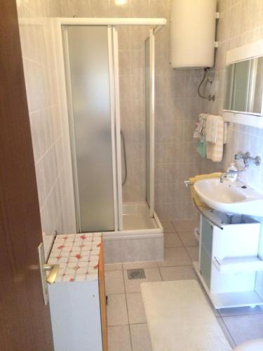 a bathroom with a shower and a sink at Apartments Esad in Kornić