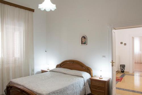 a bedroom with a bed and a dresser with two candles at Casa Vacanze Maria&Vito in Veglie