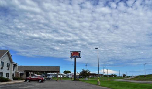 a car parked in a parking lot with a sign at FairBridge Inn & Suites Thorp in Thorp