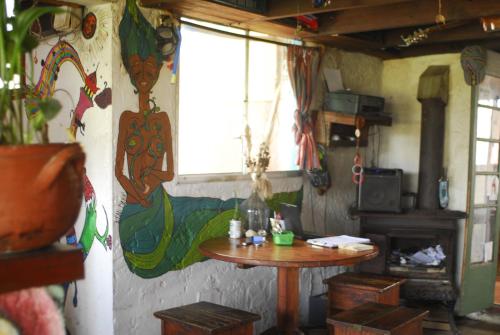a small table in a room with a window and a table at Viejo Lobo in Cabo Polonio