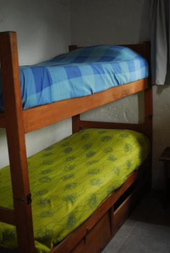 two bunk beds in a room with a yellow mattress at Viejo Lobo in Cabo Polonio