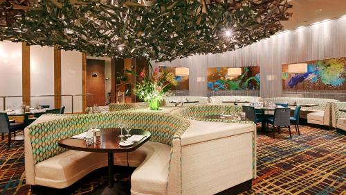 a restaurant with tables and chairs and a large ceiling at Grand Sierra Resort and Casino in Reno