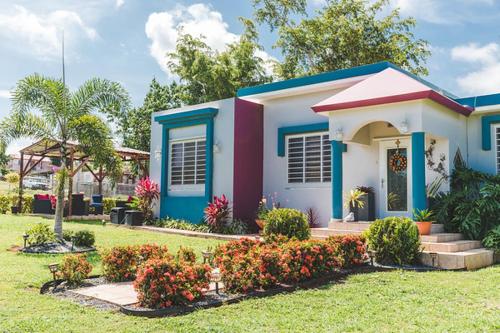 a small house in a yard with flowers at Eden's Garden in Isabela